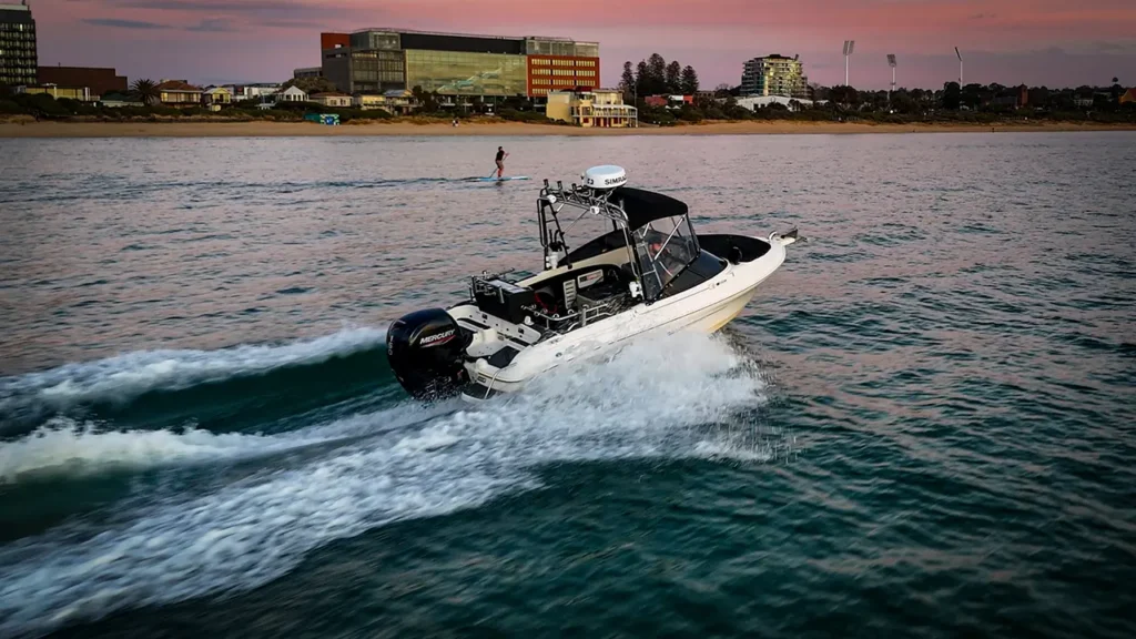 Custom Haines Signature boat with Mercury 150HP engine heading out for fishing after full boat modification by Reedy’s Rigs,boat modification, Haines Signature, Mercury 150HP outboard, fishing boat upgrade, Reedy’s Rigs, custom boat setup, Port Phillip Bay fishing, snapper fishing boat, marine electronics, AVTEK covers, boat mods Australia, boating sunset