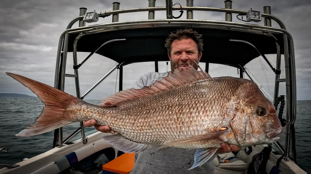 Brett Reed holding a 92cm snapper caught in Port Phillip Bay