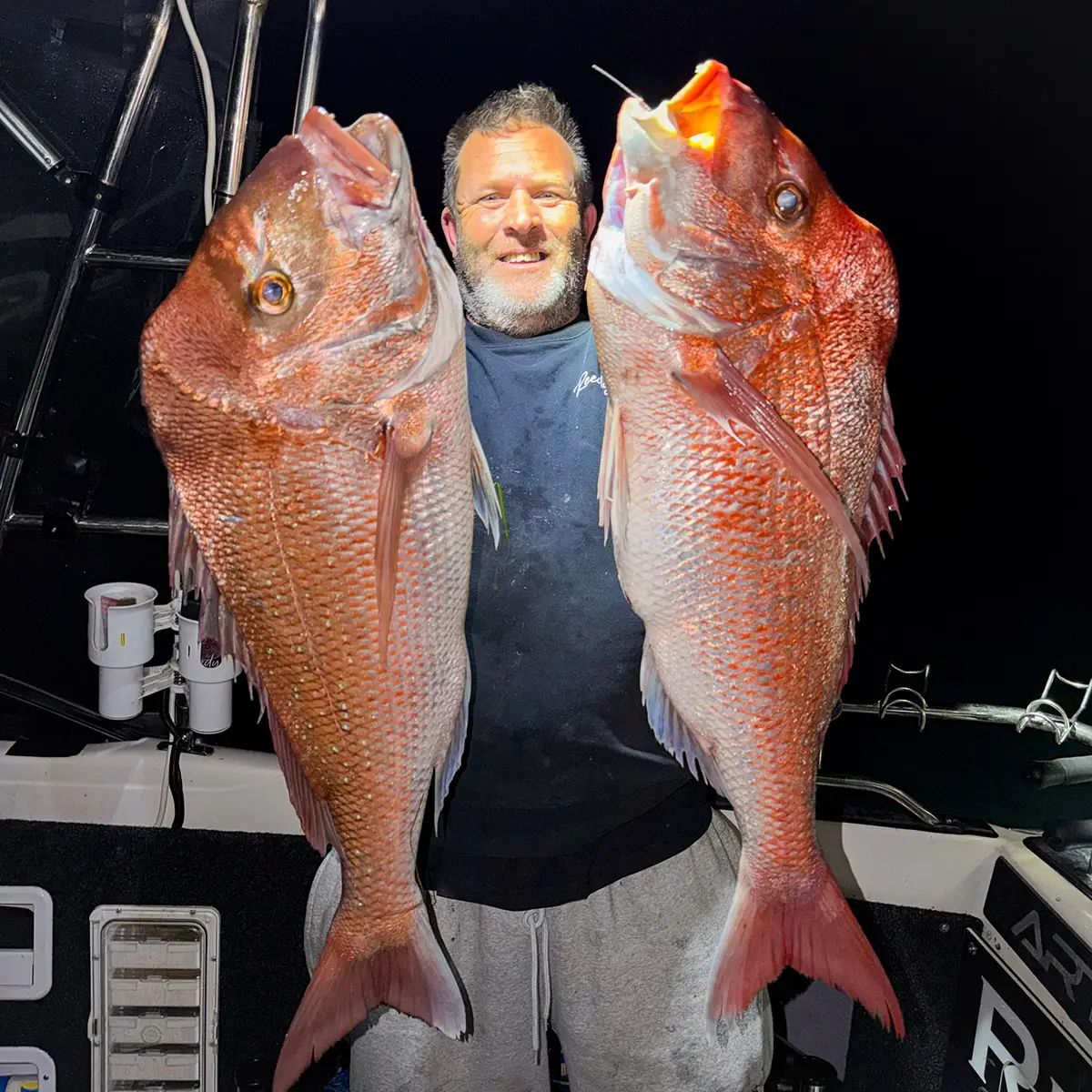 angler holding huge snapper caught on reedys rigs