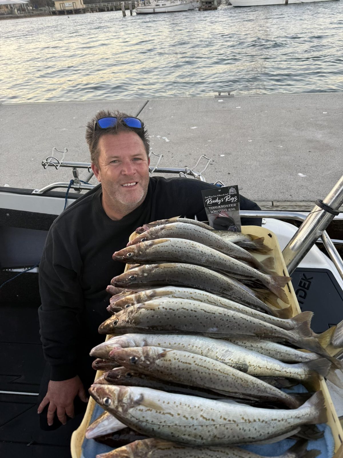 Brett Reed with Reedy's Tinganoster whiting rig and King George Whiting catch on boat at Westernport marina at dusk